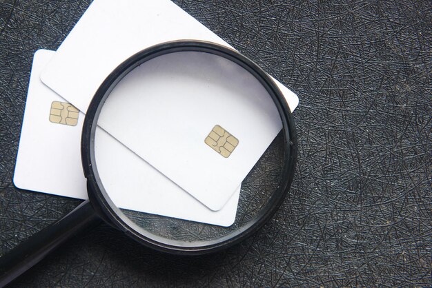 A close-up of a credit card with a magnifying glass hovering over the APR section, highlighting the importance of knowing your current interest rate.
