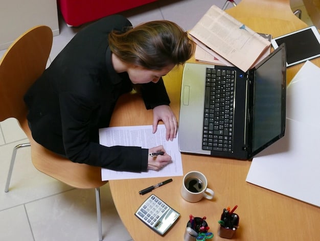A person sitting at a desk, reviewing a detailed spreadsheet on their laptop that breaks down their grocery expenses. The spreadsheet shows different categories like produce, meat, dairy, and snacks, with corresponding costs.