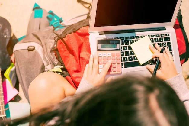 A person sitting at a desk, surrounded by newspapers, flyers, and a laptop. They are carefully clipping coupons from the newspapers while also browsing online coupon websites and apps on the laptop.