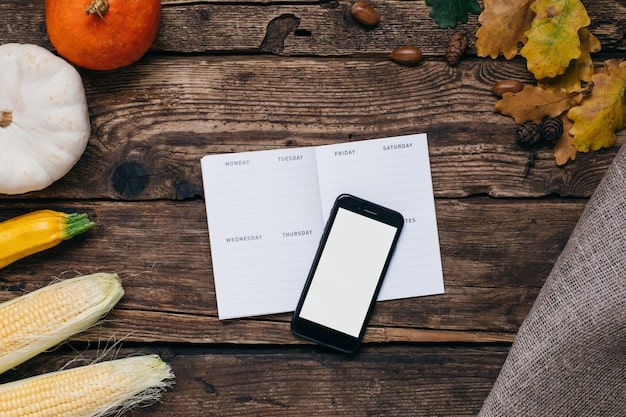 A close-up shot of a shopping list with several items crossed off. Next to the list are neatly organized grocery coupons, a store loyalty card, and a calculator.