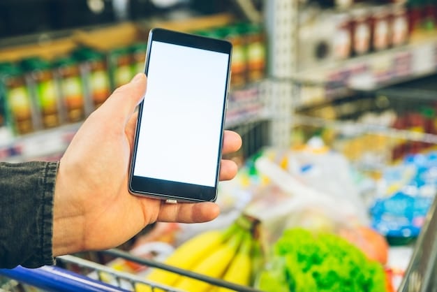 A hand holding a smartphone displaying a grocery store loyalty app with various discount offers, while shopping in a bright, modern grocery aisle.