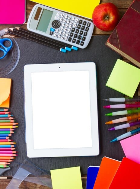A family reviewing a budget on a tablet, with textbooks and school supplies in the background, symbolizing financial planning for education and family expenses.
