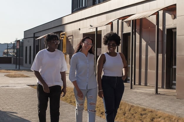 A diverse group of young adults, smiling and looking confident, walking away from a university building towards a bright future, symbolizing relief from financial burden.