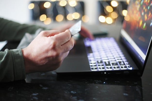 Close-up of a hand holding a credit card over a laptop keyboard, with financial charts and digital currency symbols on the screen, illustrating personal finance in a digital age.