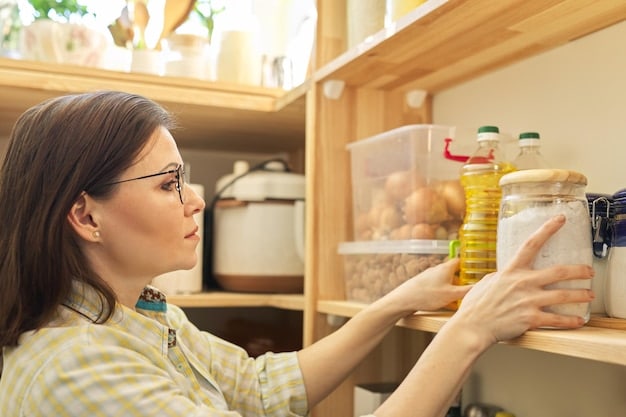 A woman organizing her pantry with clear containers and labels. The pantry is neatly arranged to show how to Reduce Food Waste, Save Money: Smart Grocery Storage Tips for Extending Shelf Life through efficient space management and easy access to stored items.