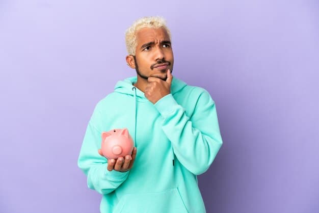 A person looking thoughtfully at a stacked pile of coins and a small piggy bank, while holding a smartphone displaying financial graphs with a downward trend line, symbolizing smart financial planning amid interest rate changes.