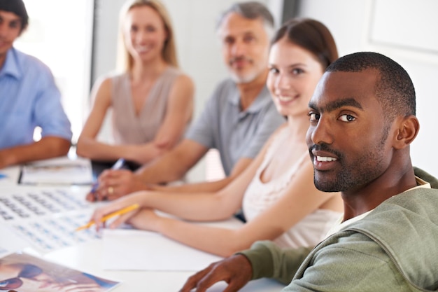 A diverse group of adults participating in a job training workshop, learning how to use advanced software and digital tools. The image represents workforce development and adaptation to new technologies.